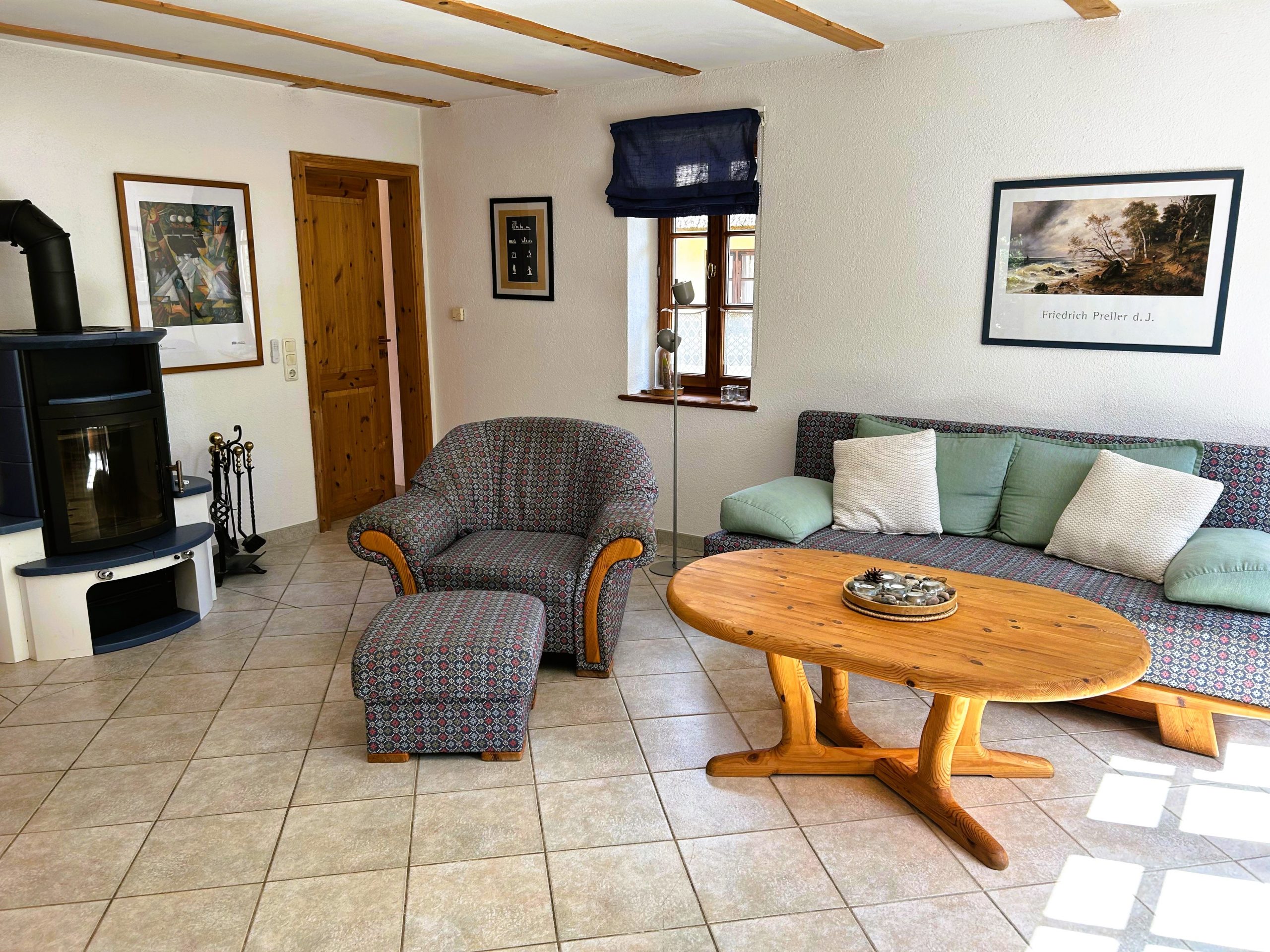 Wohnzimmer im Haus am Wiek mit Kaminofen, Sofa und Sessel